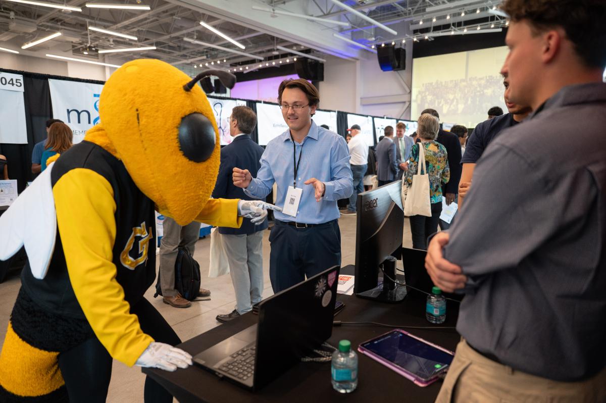 Buzz hanging out with people at exhibit